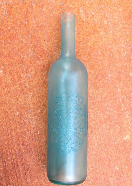 Make a Faux Sea Glass Bottle - Sea glass is still so popular, and it's a beautiful way to decorate your home in the summer.  Rather than buying new decorative accents, you can make your own using a few simple items plus recyclables.  